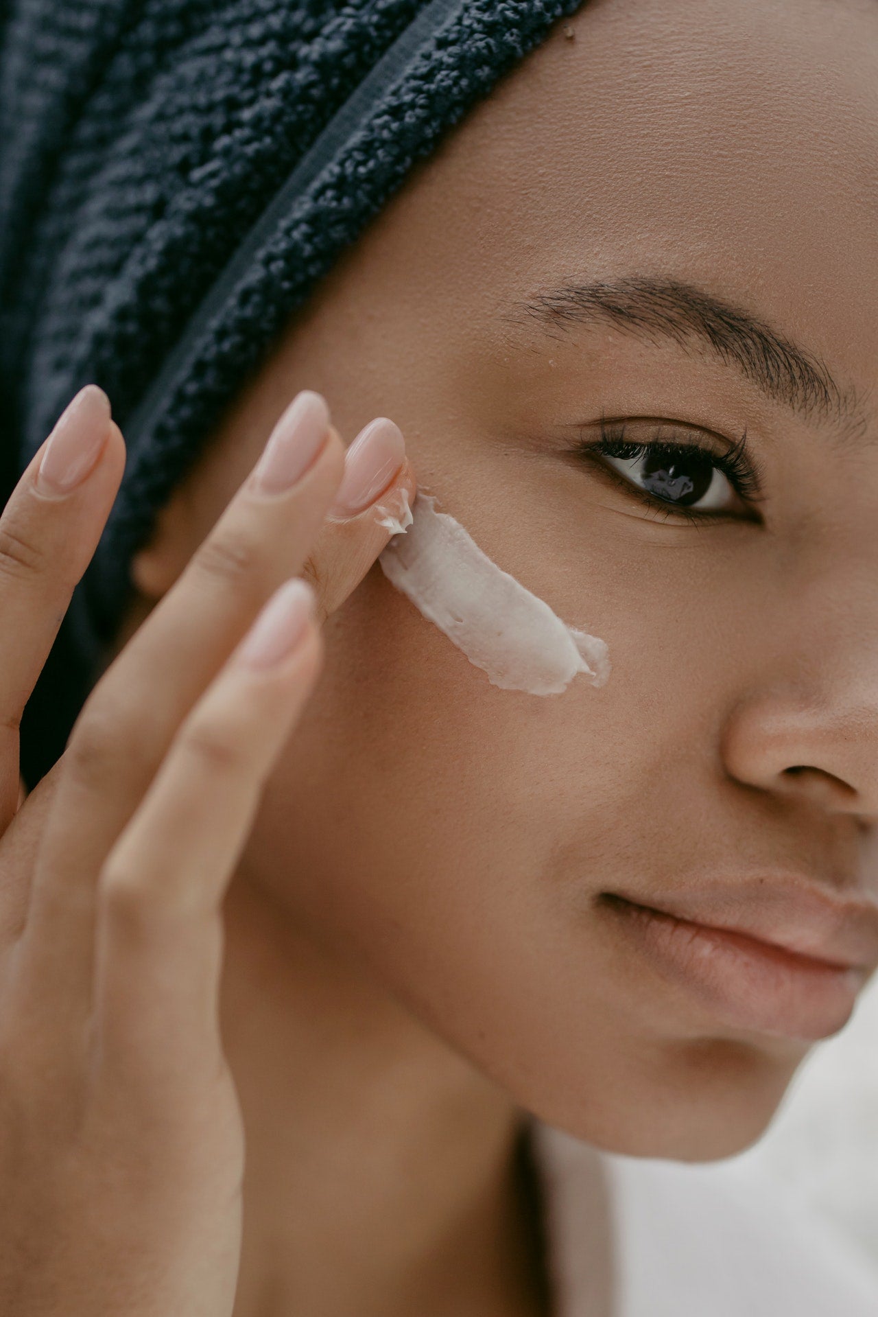 Dark Skin Woman applying cream